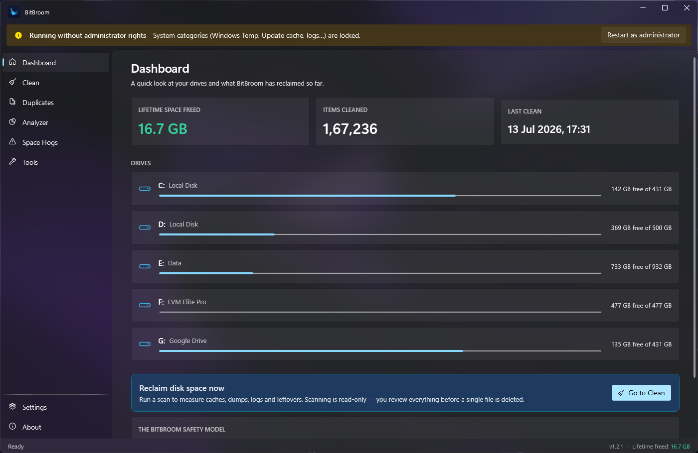 BitBroom dashboard on Windows 11 — dark acrylic UI showing drives and cleanup summary